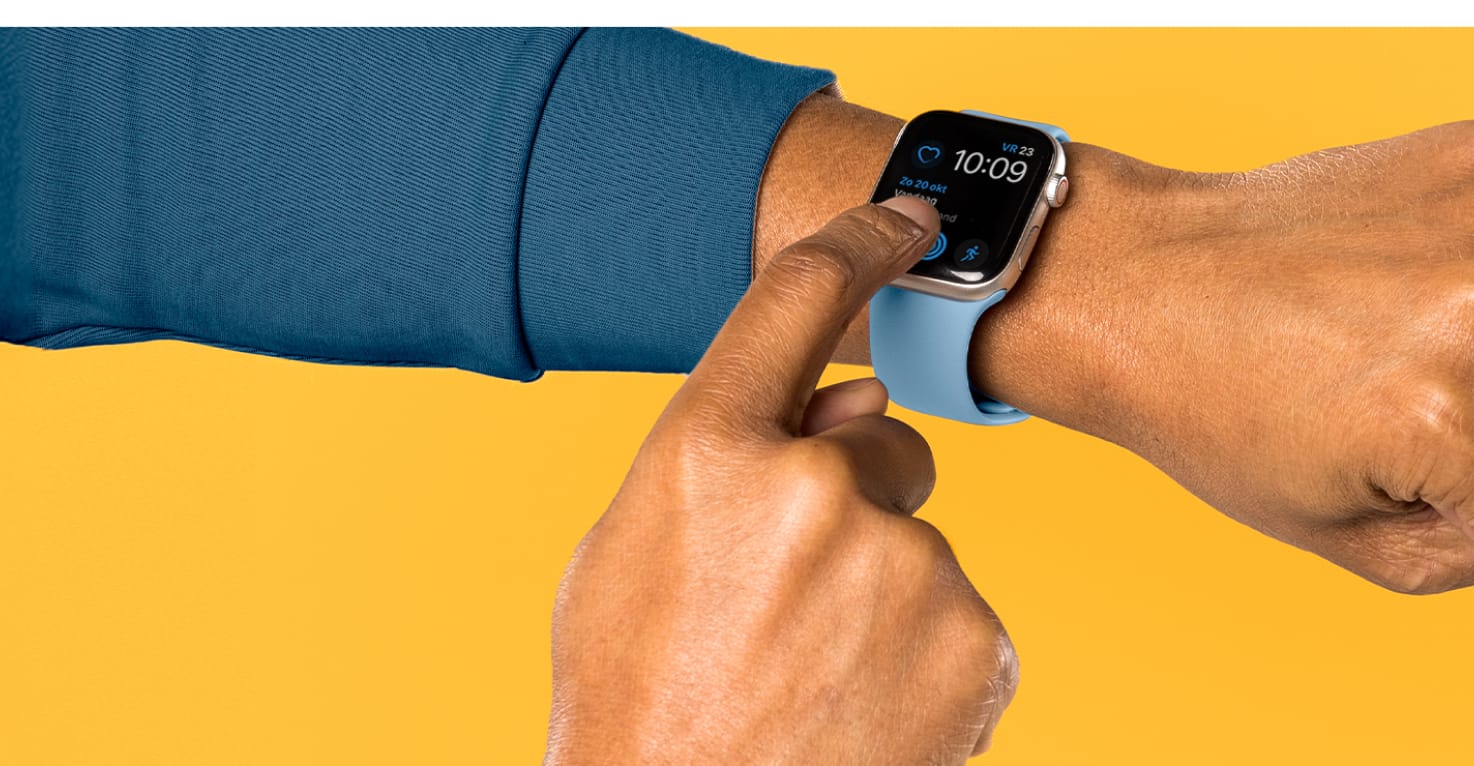 Een hand komt van links met een blauwgroene mouw op een gele achtergrond. Om de pols zit een Apple Watch met lichtblauw siliconen bandje die wordt bediend door de andere hand.
